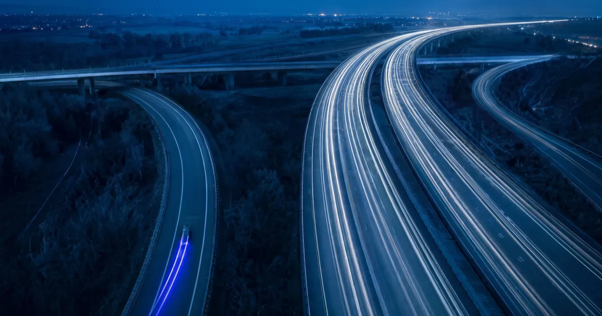 Aerial photo of traffic diverting onto a new flyover and leaving an old exit road empty, showing how AI Overviews cause a traffic drop