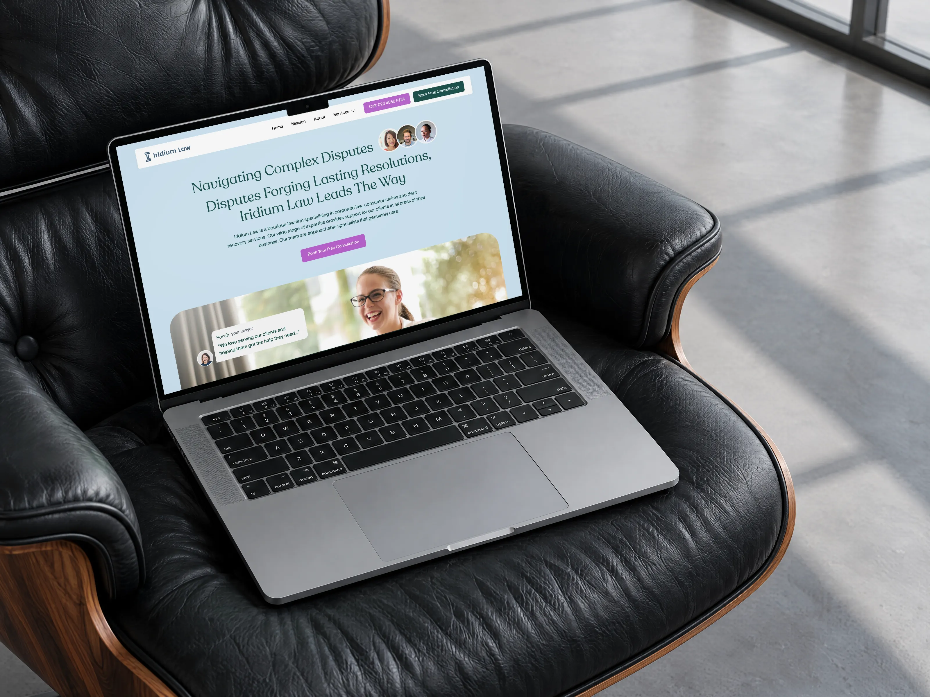 Iridium Law website design on a MacBook Pro resting on a black leather lounge chair